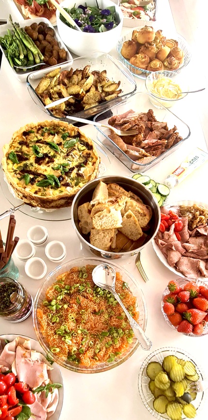Buffet for 17 may. Food on a white table.