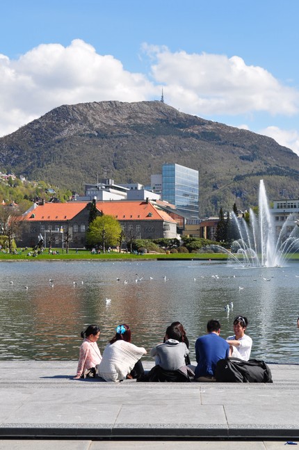En gjeng med studenter som sitter langs lille Lungegårdsvannet. 
