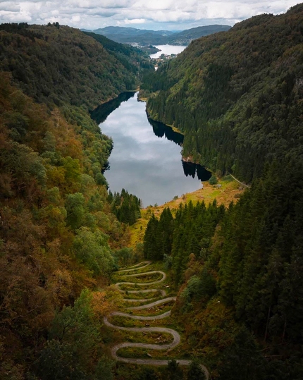 Aerial view of the hairpin bends, a lake and autumn colors.
