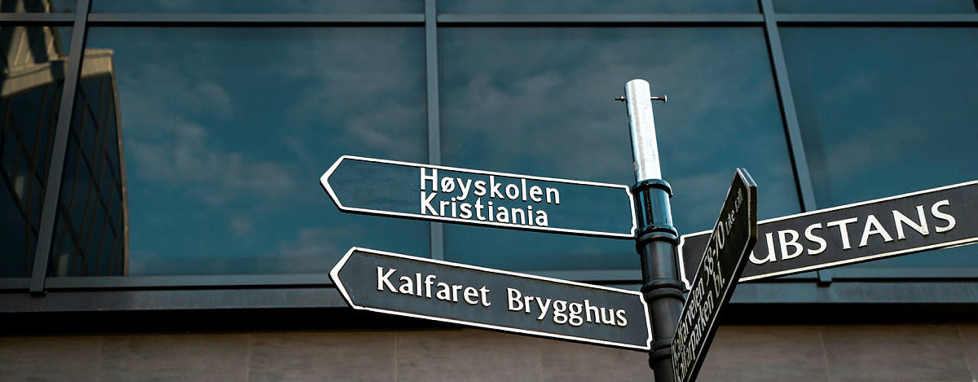 Road signs outside the Kristiania Campus in Bergen, showing the way to the university college.