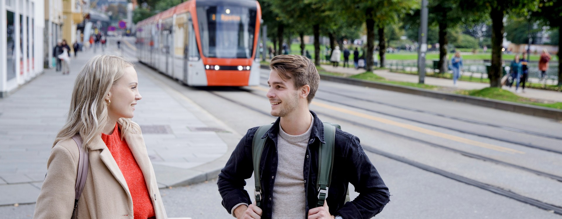 Students waiting for the Lightrail. Two students in a Bergen street in front of the Bergen Light Rail. Photo