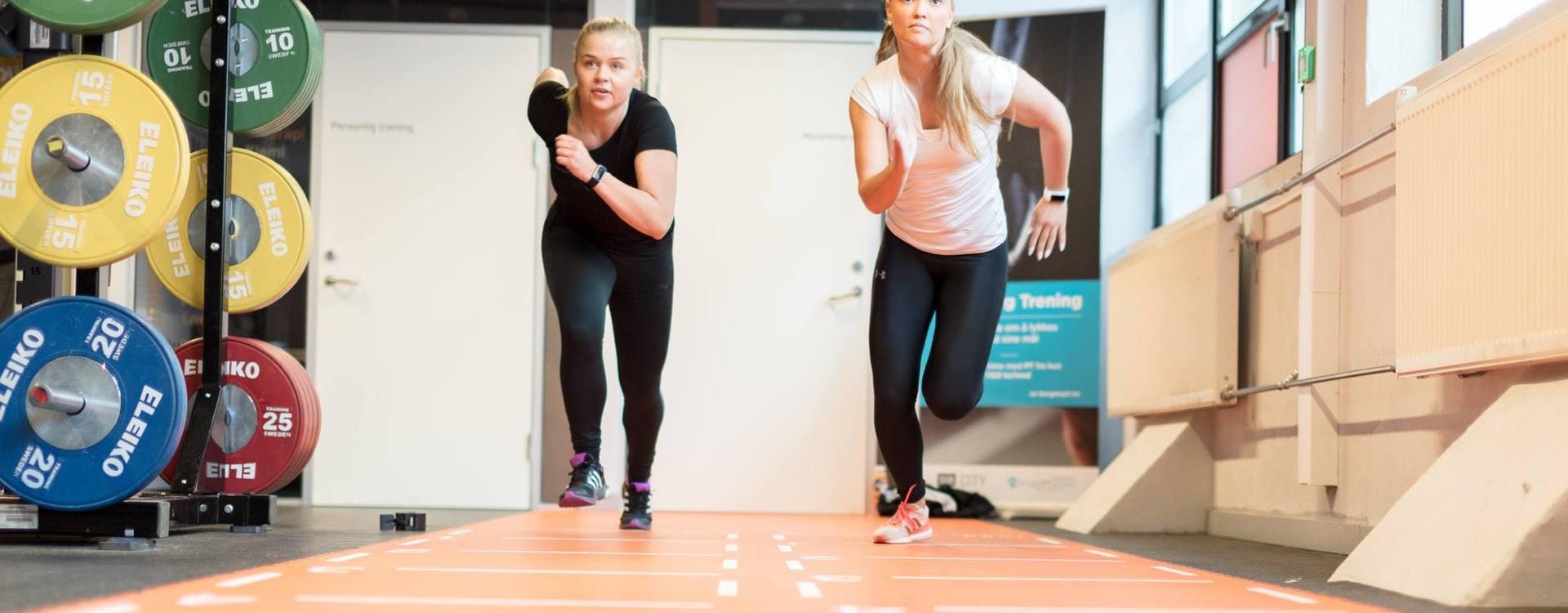 Two persons running indoor.