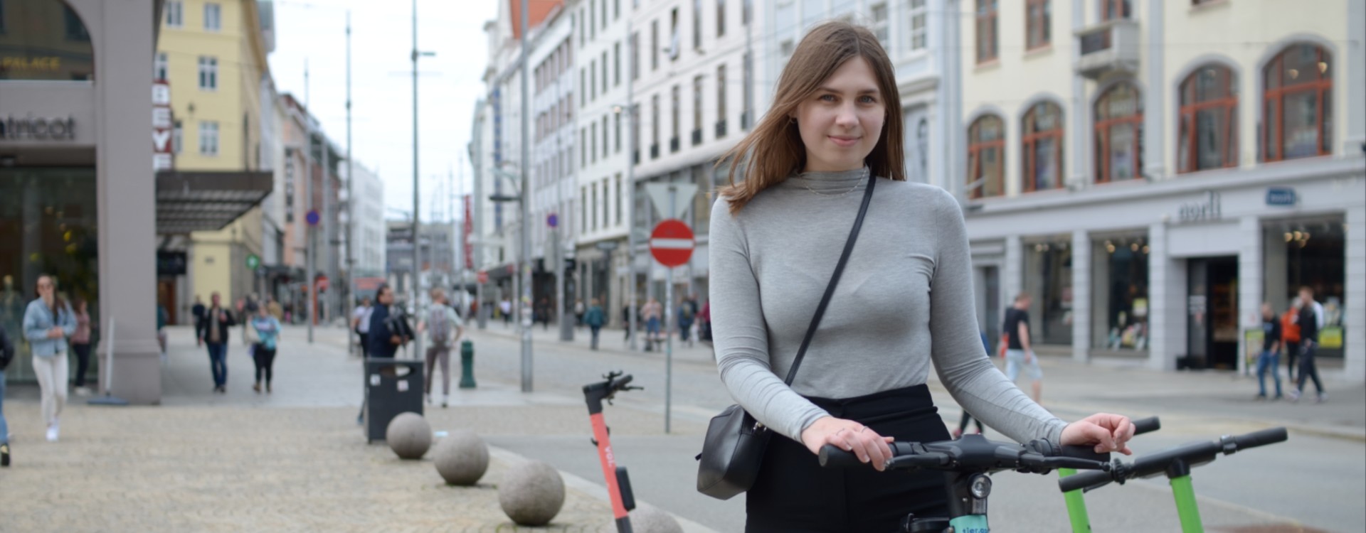A girl with an electric scooter in Bergen.