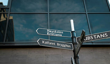 Road signs outside the Kristiania Campus in Bergen, showing the way to the university college.